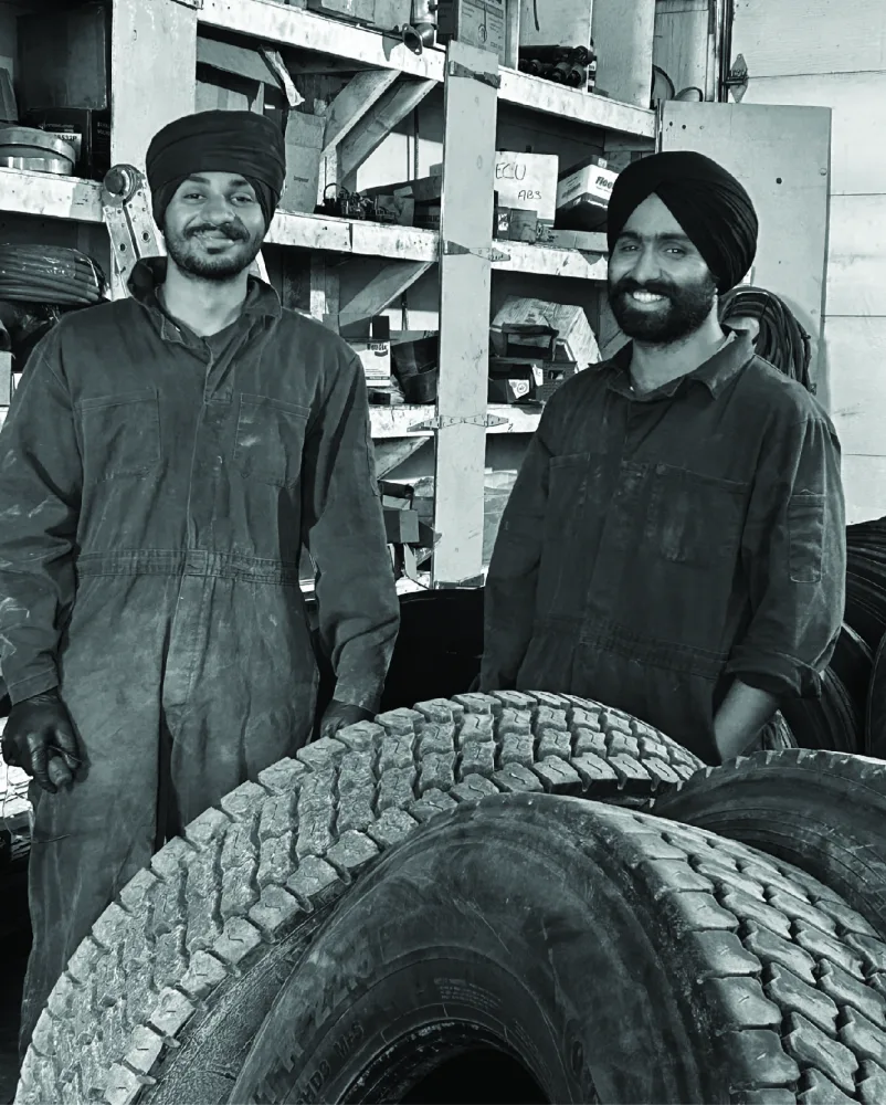 Two team members in the truck maintenance workshop