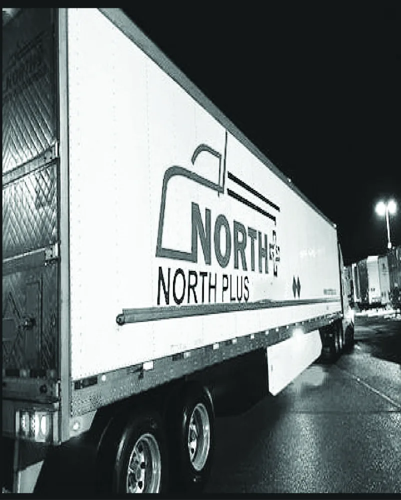 Company trailer parked in the yard at night